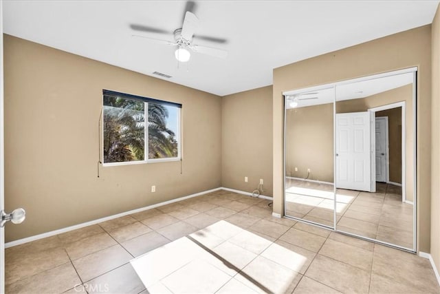 7415 Saladin Ave Unit 29, Palms, CA 92277 - unfurnished bedroom with tile patterned floors, a closet, baseboards, and ceiling fan