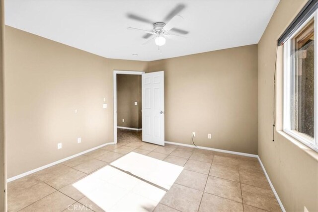 7415 Saladin Ave Unit 29, Palms, CA 92277 - spare room with a ceiling fan, light tile patterned flooring, baseboards, and healthy amount of natural light