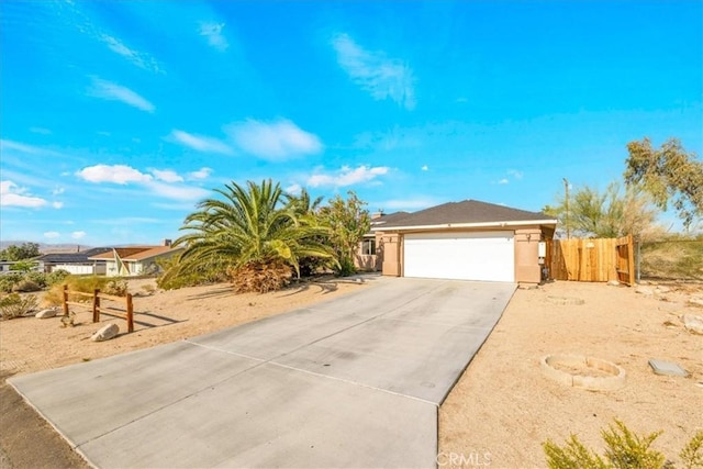 7415 Saladin Ave Unit 29, Palms, CA 92277 - view of front of property with concrete driveway, an attached garage, and stucco siding