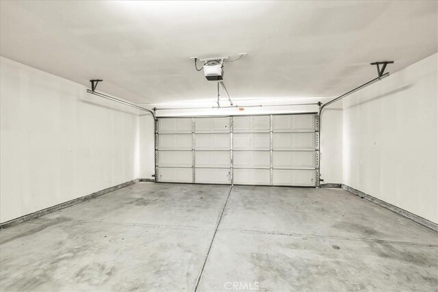 7415 Saladin Ave Unit 29, Palms, CA 92277 - garage with a garage door opener and baseboards
