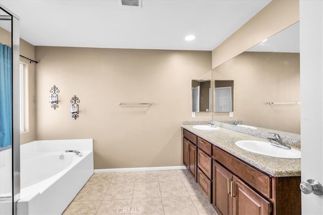 7415 Saladin Ave Unit 29, Palms, CA 92277 - full bath with double vanity, a garden tub, tile patterned floors, and baseboards