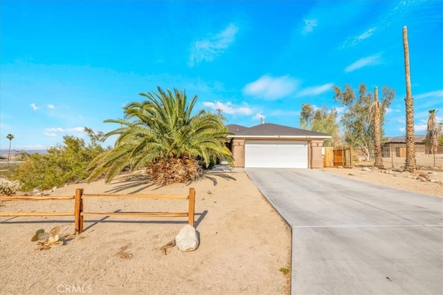 7415 Saladin Ave Unit 29, Palms, CA 92277 - view of front facade with concrete driveway and an attached garage