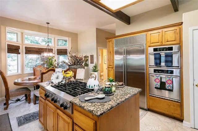 430 Rainier Rd, Lake Arrowhead, CA 92352 - kitchen with stainless steel appliances, light stone countertops, a kitchen island, baseboards, and pendant lighting