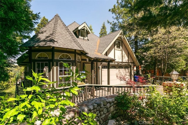 430 Rainier Rd, Lake Arrowhead, CA 92352 - tudor home featuring a shingled roof and stucco siding