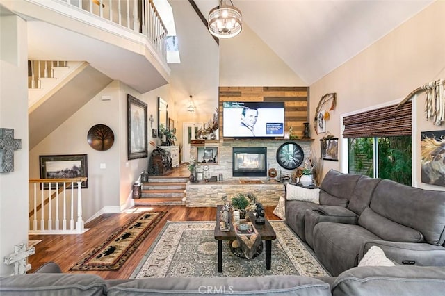 430 Rainier Rd, Lake Arrowhead, CA 92352 - living room featuring high vaulted ceiling, stairs, wood finished floors, baseboards, and a stone fireplace
