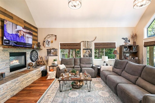 430 Rainier Rd, Lake Arrowhead, CA 92352 - living area with lofted ceiling, wood finished floors, and a stone fireplace
