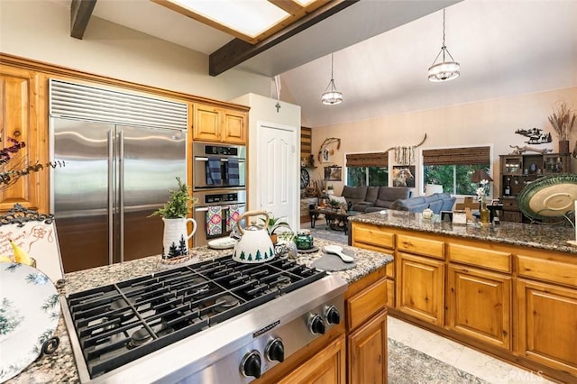 430 Rainier Rd, Lake Arrowhead, CA 92352 - kitchen featuring stainless steel appliances, dark stone countertops, decorative light fixtures, open floor plan, and brown cabinetry