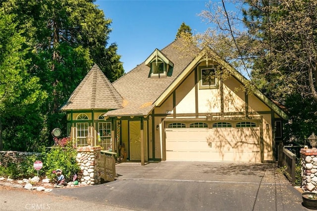 430 Rainier Rd, Lake Arrowhead, CA 92352 - english style home featuring roof with shingles, stucco siding, an attached garage, and driveway