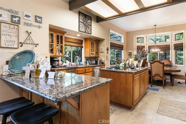 430 Rainier Rd, Lake Arrowhead, CA 92352 - kitchen with brown cabinets, a kitchen island, glass insert cabinets, dishwasher, and dark stone countertops