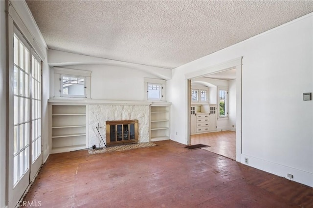 542 Ojai Rd, Santa Paula, CA 93060 - unfurnished living room featuring plenty of natural light, a premium fireplace, a textured ceiling, wood finished floors, and arched walkways