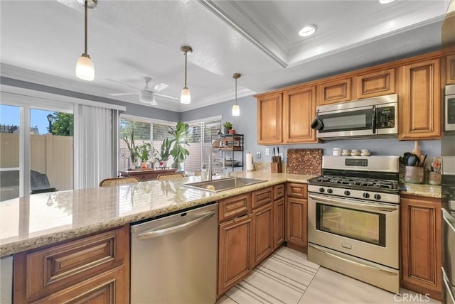 2940 Cherry Way, Ontario, CA 91761 - kitchen featuring appliances with stainless steel finishes, a sink, brown cabinets, crown molding, and hanging light fixtures
