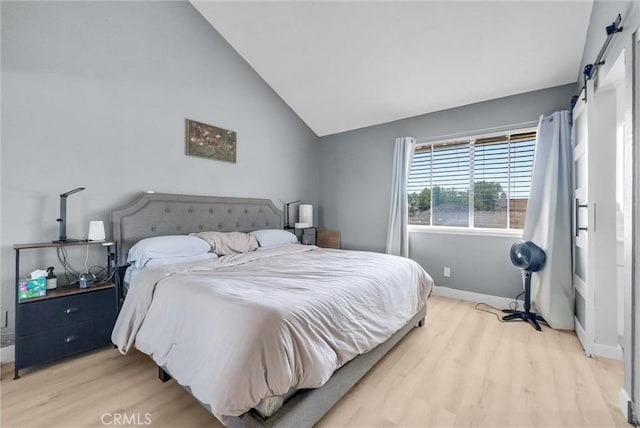 2940 Cherry Way, Ontario, CA 91761 - bedroom with light wood-style flooring, a barn door, baseboards, and vaulted ceiling