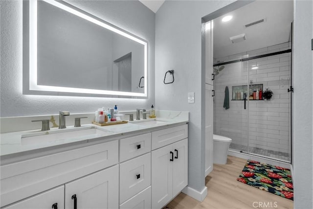 2940 Cherry Way, Ontario, CA 91761 - bathroom with toilet, wood finished floors, double vanity, and a stall shower