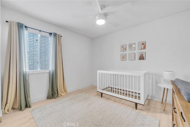 2940 Cherry Way, Ontario, CA 91761 - bedroom with wood finished floors, ceiling fan, and a crib