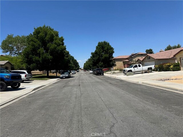 1538 Regents St, Lancaster, CA 93534 - view of asphalt road with sidewalks, curbs, and a residential view