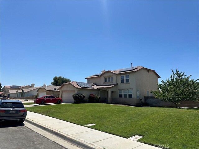 1538 Regents St, Lancaster, CA 93534 - view of front of property featuring a garage, roof mounted solar panels, stucco siding, and driveway