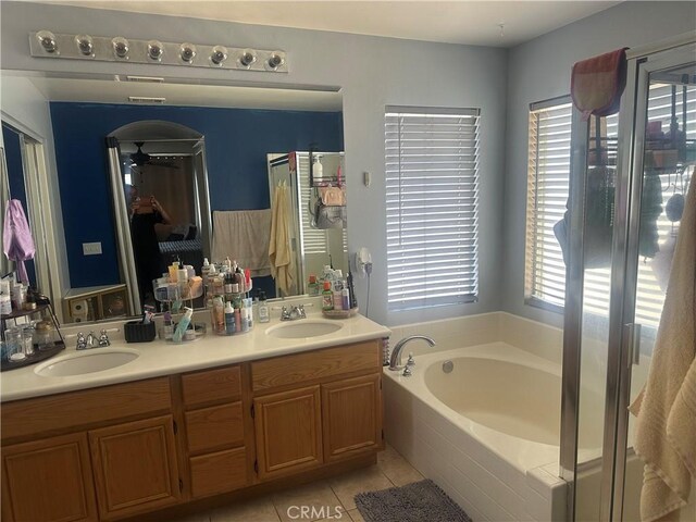1538 Regents St, Lancaster, CA 93534 - bathroom featuring healthy amount of natural light, tile patterned floors, a bath, and double vanity