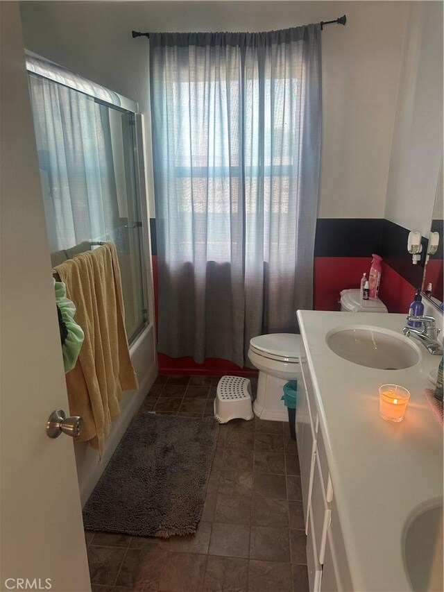 1538 Regents St, Lancaster, CA 93534 - full bathroom with double vanity, enclosed tub / shower combo, and tile patterned flooring