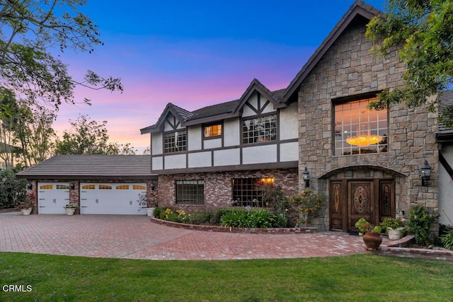 11395 Highridge Ct, Camarillo, CA 93012 - view of front facade with stucco siding, stone siding, an attached garage, driveway, and a front lawn