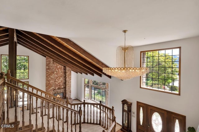 11395 Highridge Ct, Camarillo, CA 93012 - foyer entrance with a chandelier, plenty of natural light, high vaulted ceiling, a fireplace, and stairs