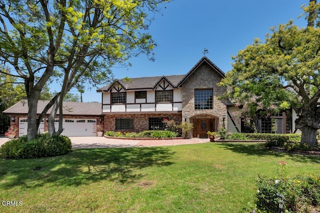 11395 Highridge Ct, Camarillo, CA 93012 - tudor-style house with a garage, stone siding, a front lawn, driveway, and stucco siding