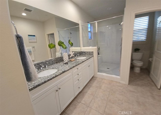 14332 Hibiscus Ct, Westminster, CA 92683 - full bathroom featuring toilet, double vanity, a shower stall, and tile patterned flooring