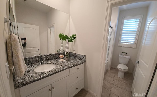 14332 Hibiscus Ct, Westminster, CA 92683 - bathroom with vanity, toilet, shower / bathtub combination, tile patterned flooring, and baseboards