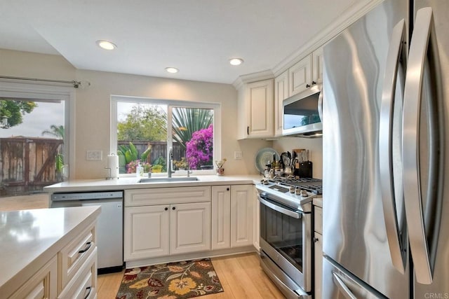 1651 S Juniper St Unit 106, Escondido, CA 92025 - kitchen featuring appliances with stainless steel finishes, a sink, light wood finished floors, light countertops, and recessed lighting