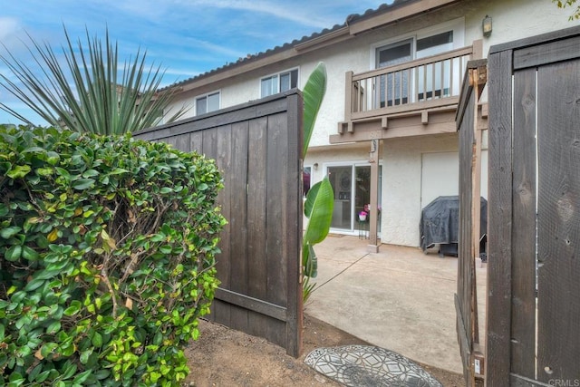 1651 S Juniper St Unit 106, Escondido, CA 92025 - back of property with stucco siding, a balcony, and a patio area