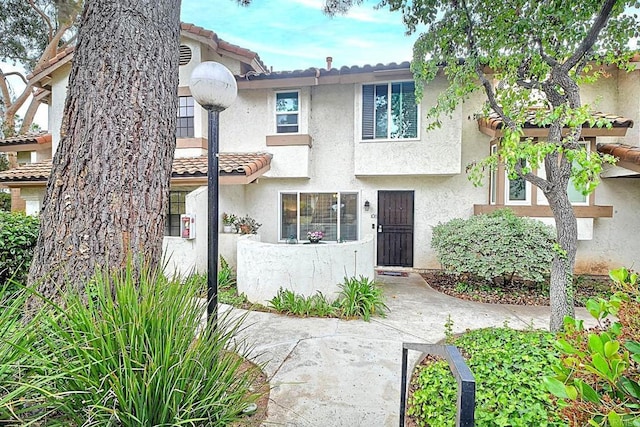 1651 S Juniper St Unit 106, Escondido, CA 92025 - view of front of home with stucco siding and a tiled roof