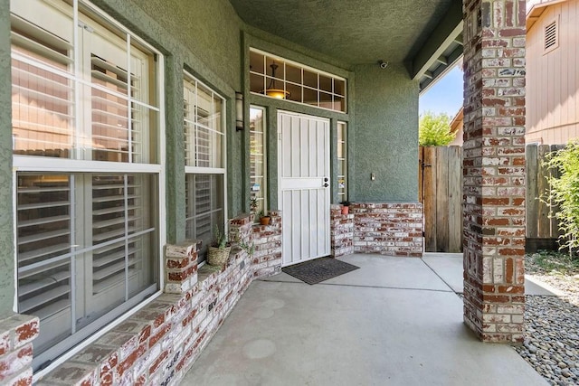 3475 Paseo Verde Ave, Merced, CA 95348 - entrance to property featuring stucco siding, covered porch, and a security system