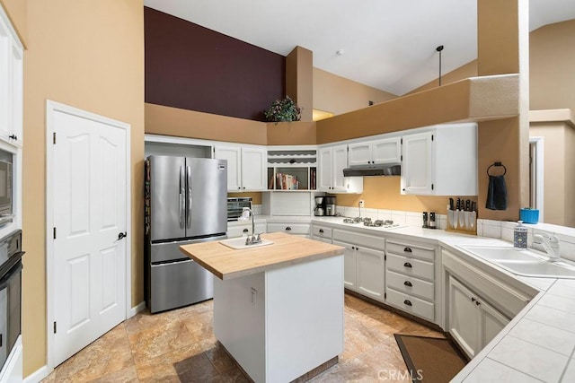 3475 Paseo Verde Ave, Merced, CA 95348 - kitchen featuring freestanding refrigerator, high vaulted ceiling, a sink, butcher block counters, and under cabinet range hood