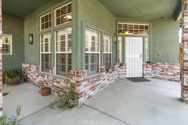 3475 Paseo Verde Ave, Merced, CA 95348 - view of exterior entry featuring stucco siding, covered porch, and a security system