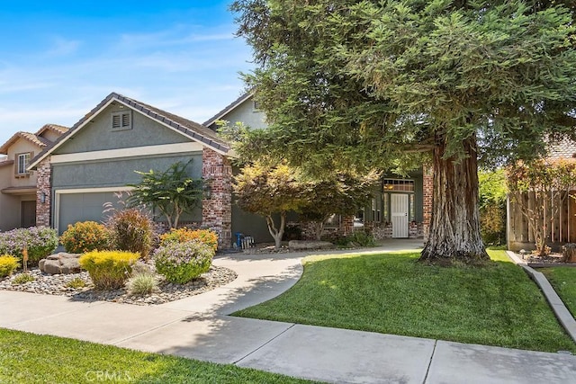 3475 Paseo Verde Ave, Merced, CA 95348 - view of front facade featuring stucco siding, a front yard, and a garage
