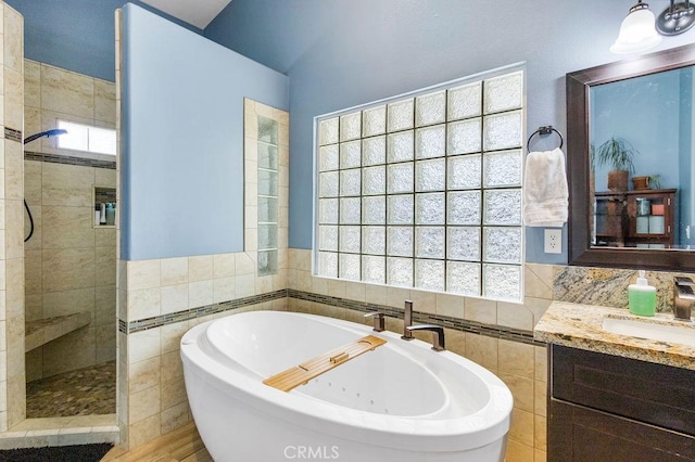 3475 Paseo Verde Ave, Merced, CA 95348 - full bath featuring a freestanding tub, walk in shower, vanity, and tile walls