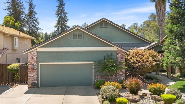 3475 Paseo Verde Ave, Merced, CA 95348 - view of front facade with an attached garage, stucco siding, concrete driveway, and brick siding