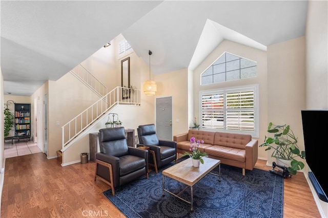 37398 Harrow Ct, Palmdale, CA 93550 - living room with wood finished floors, stairs, and high vaulted ceiling