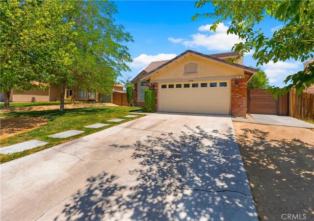 37398 Harrow Ct, Palmdale, CA 93550 - view of front of home featuring a garage, concrete driveway, brick siding, and stucco siding