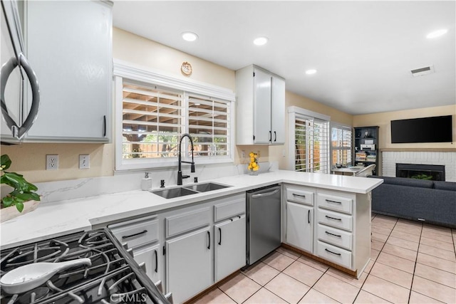 37398 Harrow Ct, Palmdale, CA 93550 - kitchen with a peninsula, stainless steel dishwasher, open floor plan, light tile patterned floors, and stove