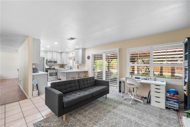 37398 Harrow Ct, Palmdale, CA 93550 - living room featuring light tile patterned floors and a desk
