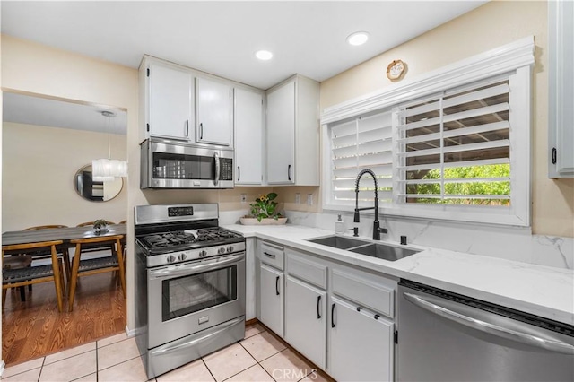 37398 Harrow Ct, Palmdale, CA 93550 - kitchen with stainless steel appliances, light tile patterned floors, light stone countertops, and recessed lighting
