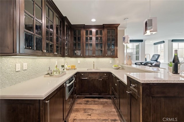 2711 Elm Ave, Manhattan Beach, CA 90266 - kitchen with a sink, dark brown cabinetry, dark wood-style floors, a peninsula, and recessed lighting