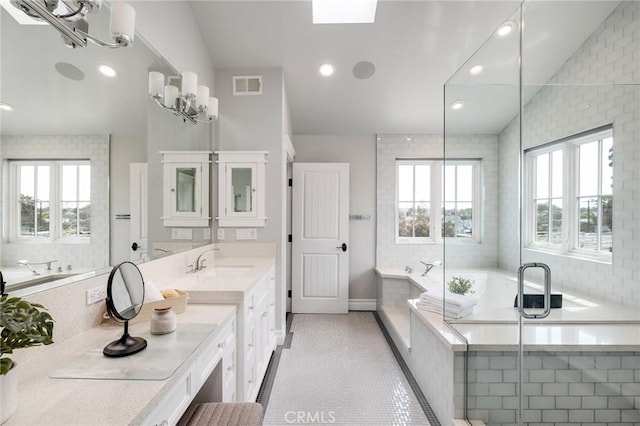 2711 Elm Ave, Manhattan Beach, CA 90266 - bathroom with healthy amount of natural light, a garden tub, vanity, recessed lighting, and tile patterned floors