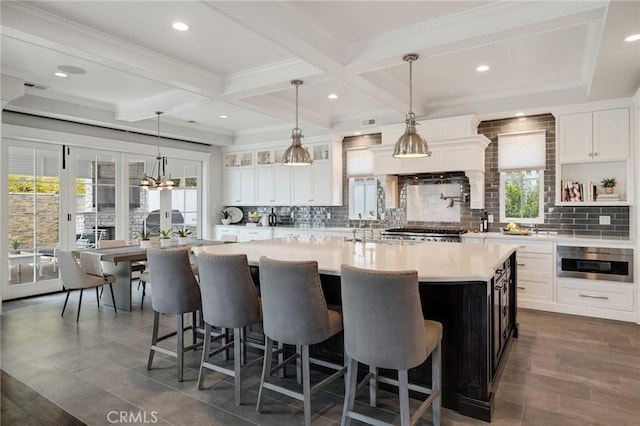 2711 Elm Ave, Manhattan Beach, CA 90266 - kitchen with light countertops, tasteful backsplash, a kitchen breakfast bar, a large island, and beamed ceiling