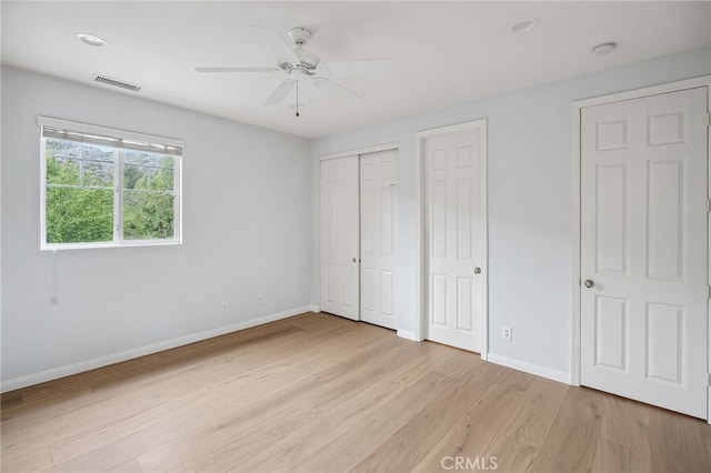 24274 Reyes Adobe Way, Valencia, CA 91354 - unfurnished bedroom with baseboards, light wood finished floors, multiple closets, and a ceiling fan