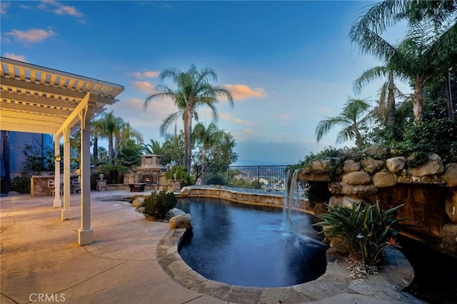 24274 Reyes Adobe Way, Valencia, CA 91354 - pool at dusk with an outdoor stone fireplace and a patio