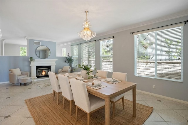 24274 Reyes Adobe Way, Valencia, CA 91354 - dining area with light tile patterned floors, crown molding, healthy amount of natural light, baseboards, and a glass covered fireplace