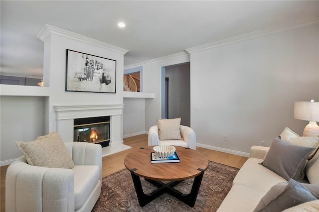 24274 Reyes Adobe Way, Valencia, CA 91354 - living area featuring crown molding, wood finished floors, a glass covered fireplace, baseboards, and recessed lighting