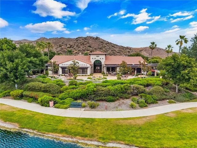 24274 Reyes Adobe Way, Valencia, CA 91354 - mediterranean / spanish house with a front yard and a water and mountain view