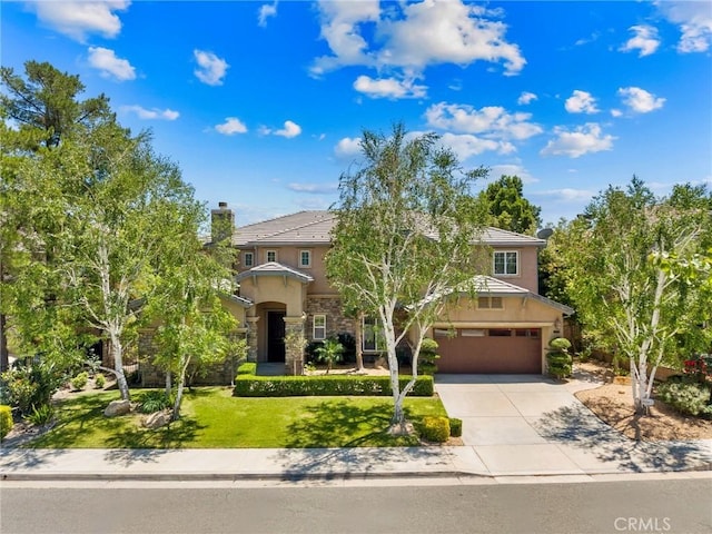 24274 Reyes Adobe Way, Valencia, CA 91354 - obstructed view of property with stucco siding, an attached garage, concrete driveway, a front lawn, and stone siding